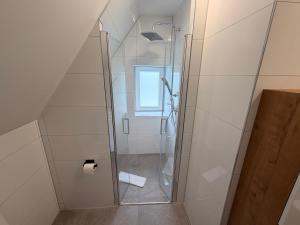 a shower with a glass door in a bathroom at HeideSuite Soltau in Soltau