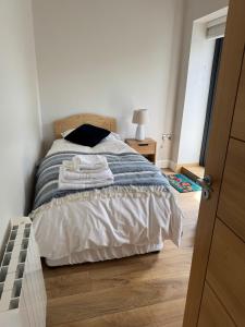 a bedroom with a bed with two towels on it at The Terrace Collection Number 2 in Tramore