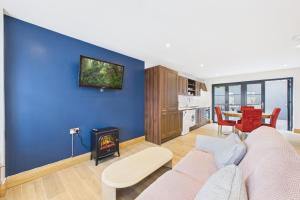 a living room with a couch and a blue wall at The Terrace Collection Number 2 in Tramore