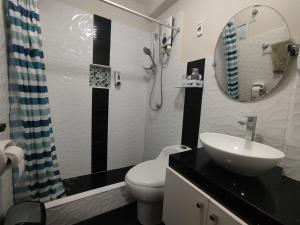 a bathroom with a toilet and a sink and a mirror at Apartamentos "APPART D'ELIETTE" in Trujillo +142 photos