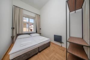 a bedroom with a large bed and a window at Slawkowska No 6 Residence in Krakow