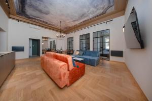 a living room with a couch and a flat screen tv at Slawkowska No 6 Residence in Krakow