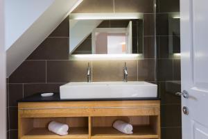 a bathroom with a sink and a mirror at The Beach in Bude