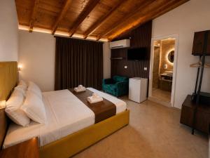 a bedroom with a large bed and a television at Vila Bello in Ksamil