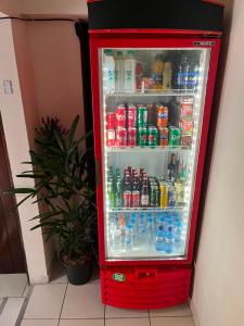 a red refrigerator filled with lots of drinks at Hotel Piracema Caruaru in Caruaru