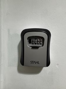 a black and white switch on a wall at Panorama Apartament in Poznań