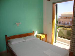 A bed or beds in a room at Alex Apartments