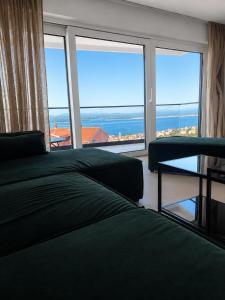 a bedroom with a bed and a view of the ocean at Apartments Villa Klaudia in Crikvenica +114 photos