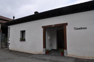 a white building with a sign on the side of it at Estudio con Rincón de Cortesía Pusantenea in Berástegui