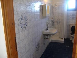 a bathroom with a sink and a toilet at Alex Apartments in Roda