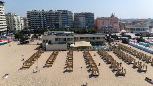 a group of tables and chairs on a beach at THE ONE Grand Hotel da Póvoa - by MHMB Hospitality in Póvoa de Varzim