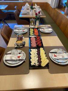 a table with several plates of food on it at Goldener Adler 