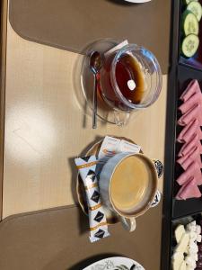 a refrigerator with a cup of coffee and cookies at Goldener Adler 
