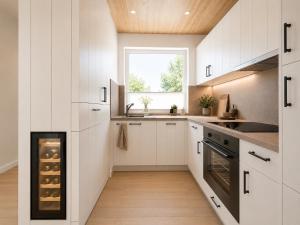 a kitchen with white cabinets and a window at Kiefernhuus 2 in Norderney