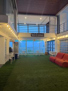 a large office with a couch in the middle of a room at serenity suites tagaytay in Tagaytay