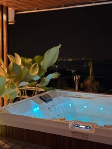 a jacuzzi tub with a view of the city at serenity suites tagaytay in Tagaytay