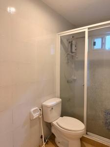 a bathroom with a toilet and a shower at serenity suites tagaytay in Tagaytay