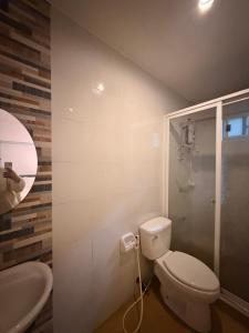 a bathroom with a toilet and a sink at serenity suites tagaytay in Tagaytay