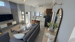 a living room with a couch and a table at SiwelaNest in Mbabane