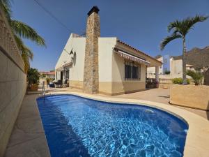 a swimming pool in front of a house at Mirador de Bolnuevo in Bolnuevo