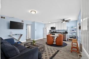 a living room with a couch and a table at Steps to Sand Updated Bouchee Beachy Condo Deck Parking in Brigantine