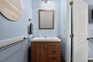 a bathroom with a sink and a mirror at Steps to Sand Updated Bouchee Beachy Condo Deck Parking in Brigantine +15 photos