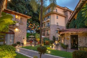 an exterior view of a building with a yard at Quinta Real Guadalajara in Guadalajara