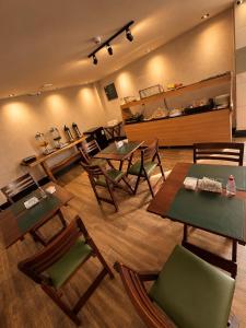 a room with tables and chairs in a store at DLUX Hotel in Campos dos Goytacazes +8 photos