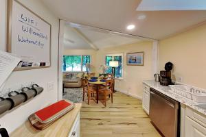 a kitchen with a table and a dining room at Water's Edge in Bucksport