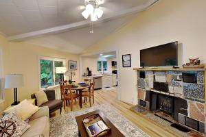 a living room with a fireplace and a tv at Water's Edge in Bucksport