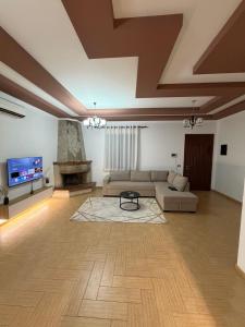 a large living room with a couch and a tv at Comfort House in Bathore