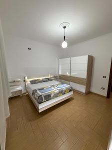 a bedroom with a bed and a wooden floor at Comfort House in Bathore