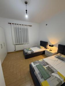 a room with two beds and a window in it at Comfort House in Bathore