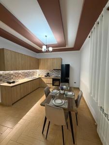 a kitchen and dining room with a table and chairs at Comfort House in Bathore