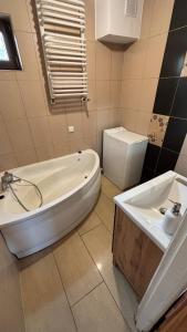 a bathroom with a tub and a toilet and a sink at Ranczo Obozin 62 in Obozin +44 photos