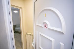 a door with a clock on it in a room at Guest house LORA in Gabrovo +72 photos