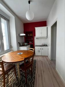 a kitchen with a wooden table in a room at Guingamp studio with garden view in Guingamp