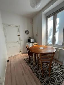 a dining room with a wooden table and a window at Guingamp studio with garden view in Guingamp