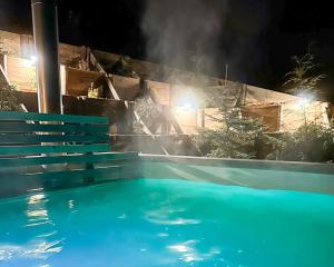 a swimming pool at night with smoke coming out at Osada Sielankowo - Kopiec in Żałe