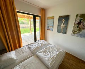 a bed sitting in a bedroom with a window at Osada Sielankowo - Kopiec in Żałe