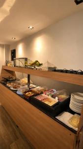 a buffet line with many different types of food at DLUX Hotel in Campos dos Goytacazes