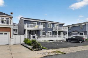 a car parked in a parking lot in front of houses at Radiant Beach Block Condo Parking Patio in Brigantine