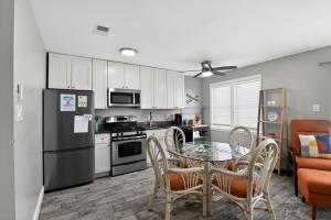 a kitchen with a table and chairs and a refrigerator at Radiant Beach Block Condo Parking Patio in Brigantine +16 photos