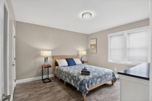a bedroom with a bed and two lamps in it at Radiant Beach Block Condo Parking Patio in Brigantine