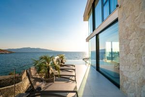 a house with a view of the water at Nube Luxury Villas in Sarandë +125 photos