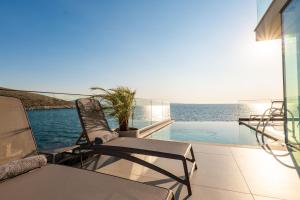 a balcony with chairs and a swimming pool at Nube Luxury Villas in Sarandë