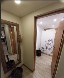 a room with a mirror and a door with a bathroom at Encanto serrano in Sierra de los Padres