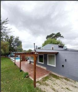a home with a patio and a house at Encanto serrano in Sierra de los Padres