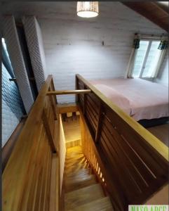 a small room with a bed on a balcony at Encanto serrano in Sierra de los Padres