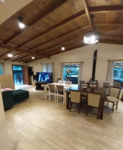 a large living room with a table and chairs at Encanto serrano in Sierra de los Padres +7 photos